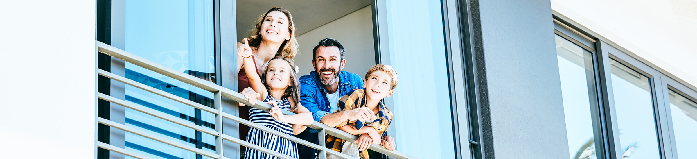 Familie guckt gespannt aus dem Fenster ihrer Ferienimmobilie_Header für den Artikel zum Kaufmarktplatz