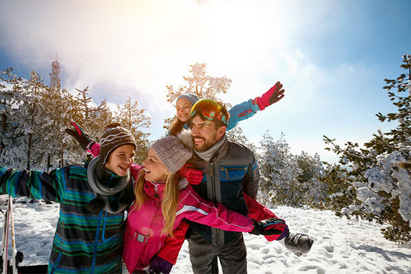 Familie in verschneiter Landschaft im Skiurlaub