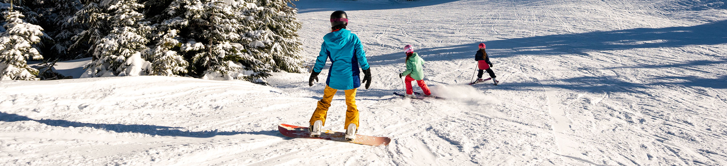 Familie im Schnee während eines Skiurlaubs mi Kindern